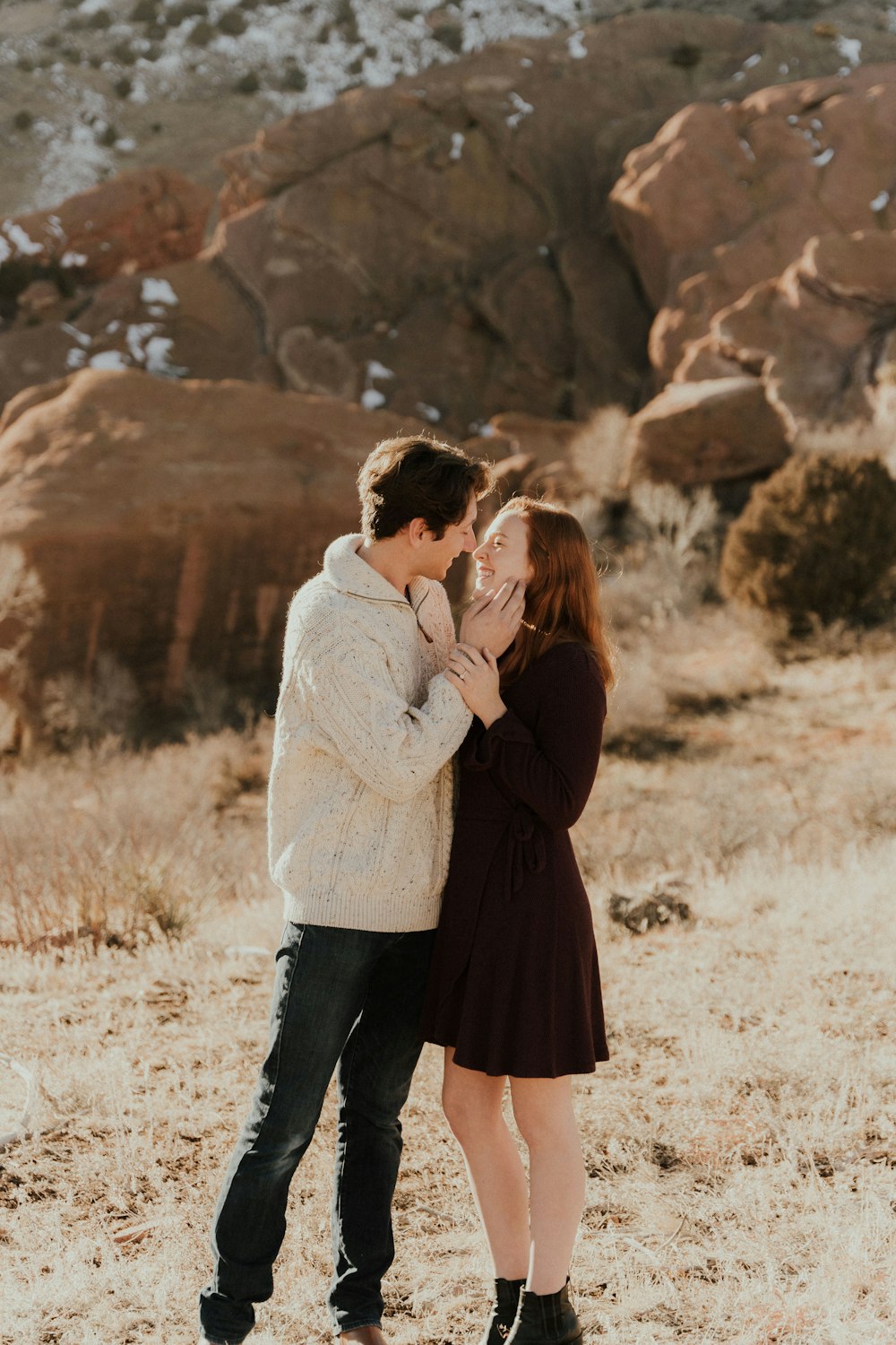 a man and a woman standing in the desert