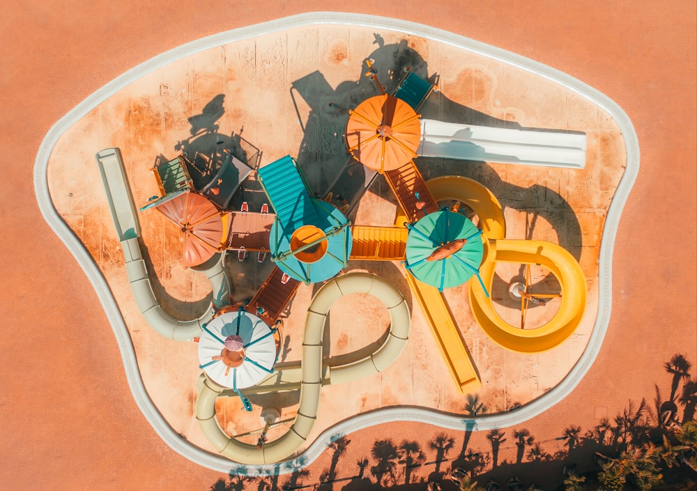 an aerial view of a pool with umbrellas and chairs