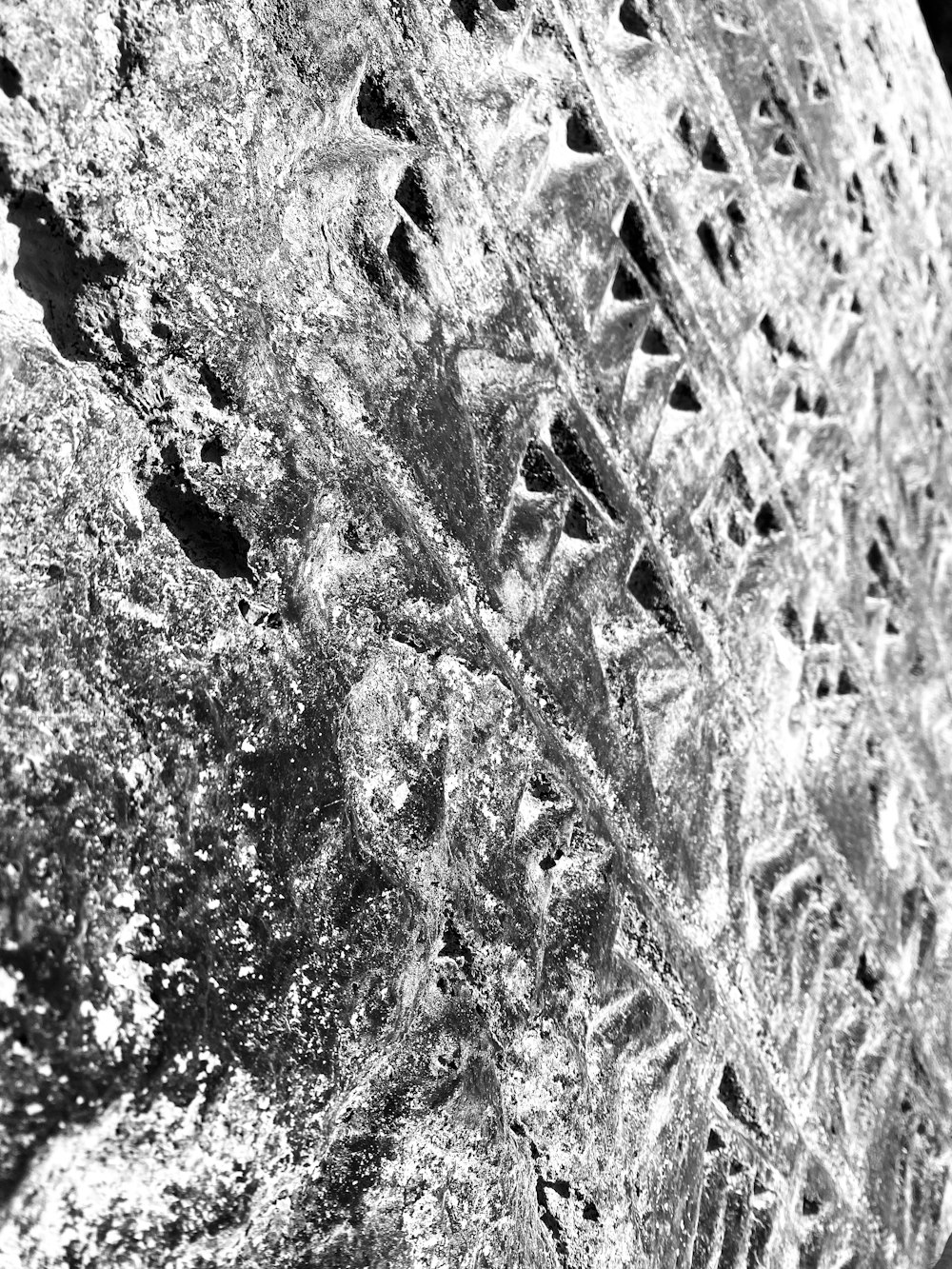 a black and white photo of a stone wall