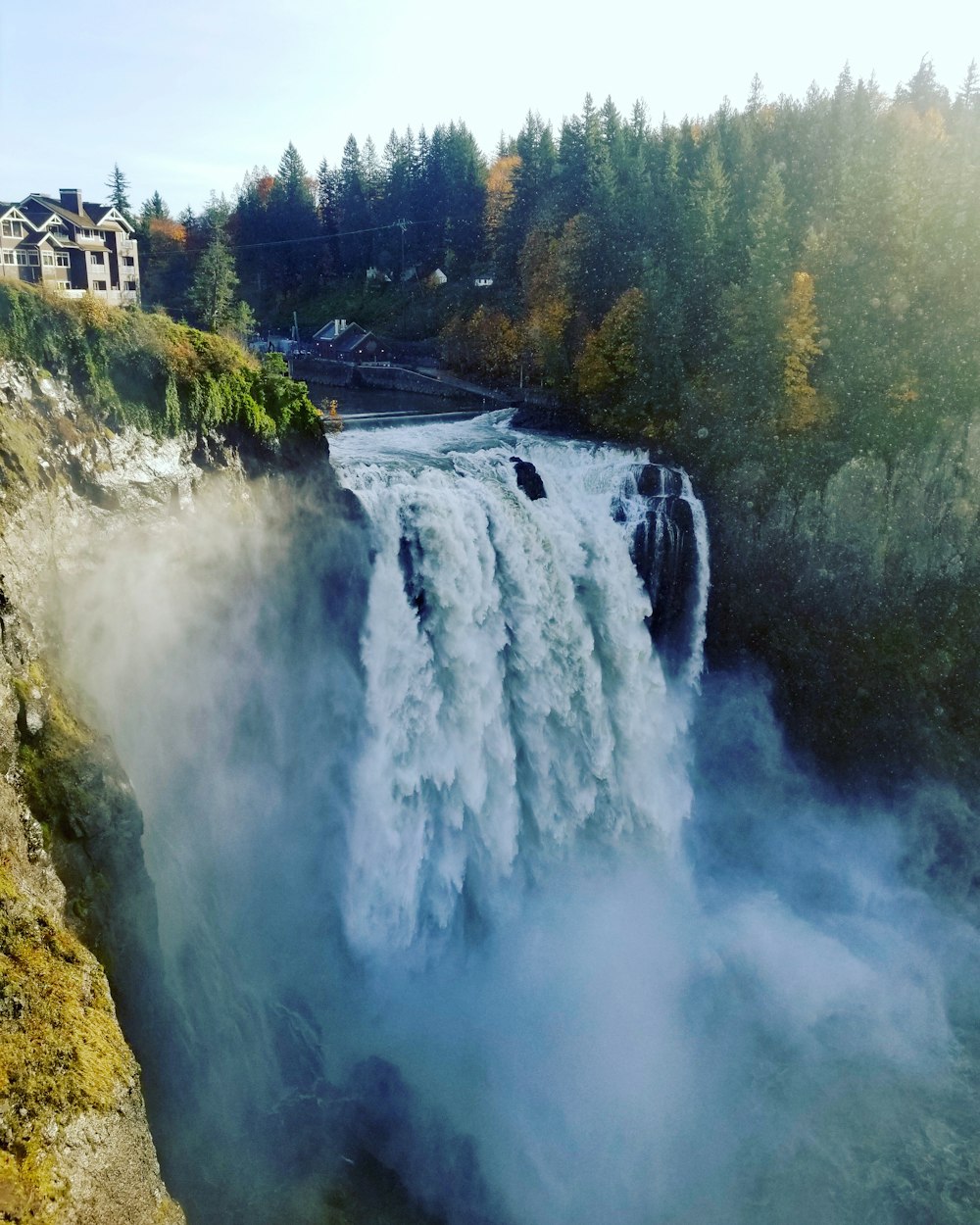 a view of a waterfall in the middle of a forest