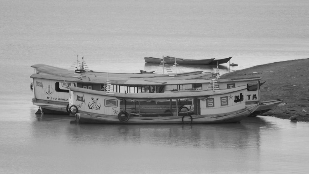 a couple of boats floating on top of a river