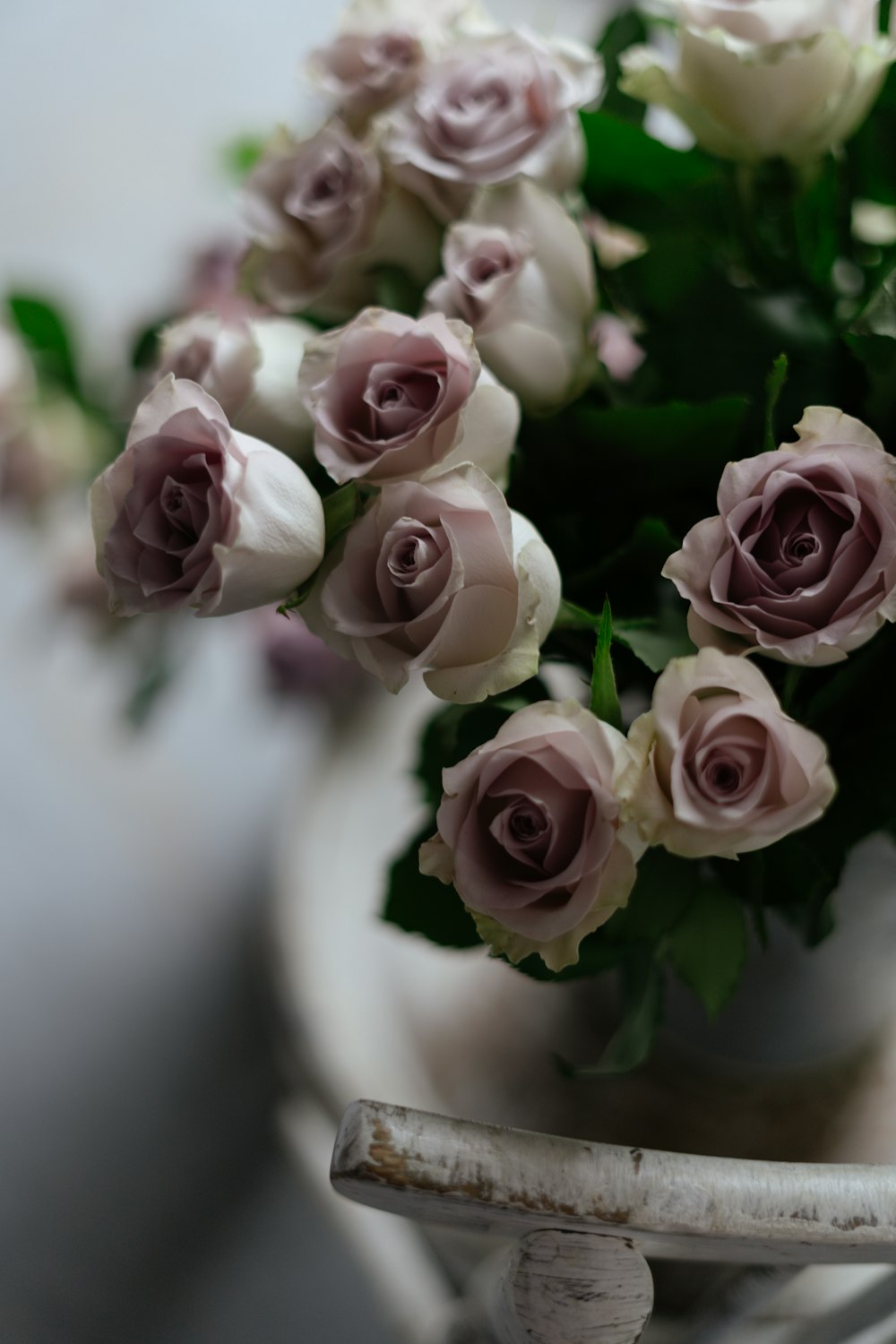 a bunch of white and pink roses in a vase