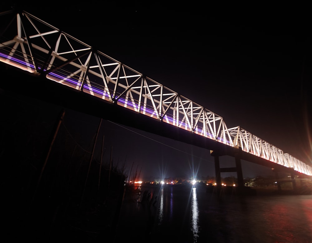 a large bridge over a body of water at night