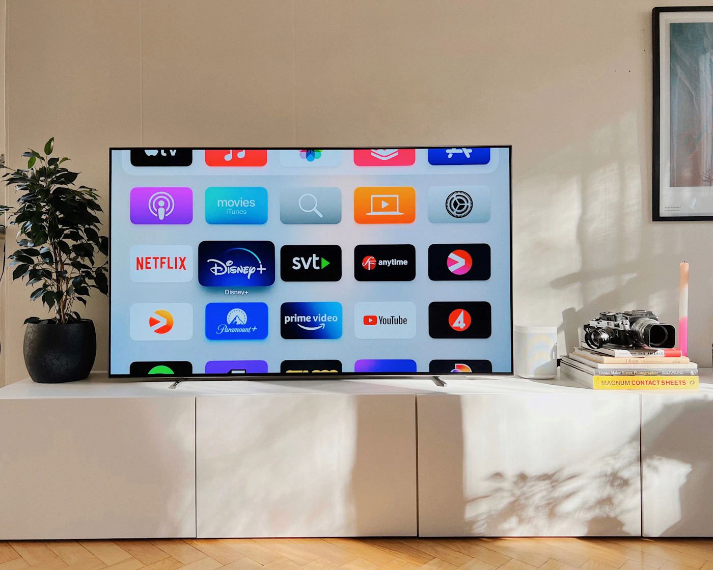 A flat screen TV on a white cabinet
