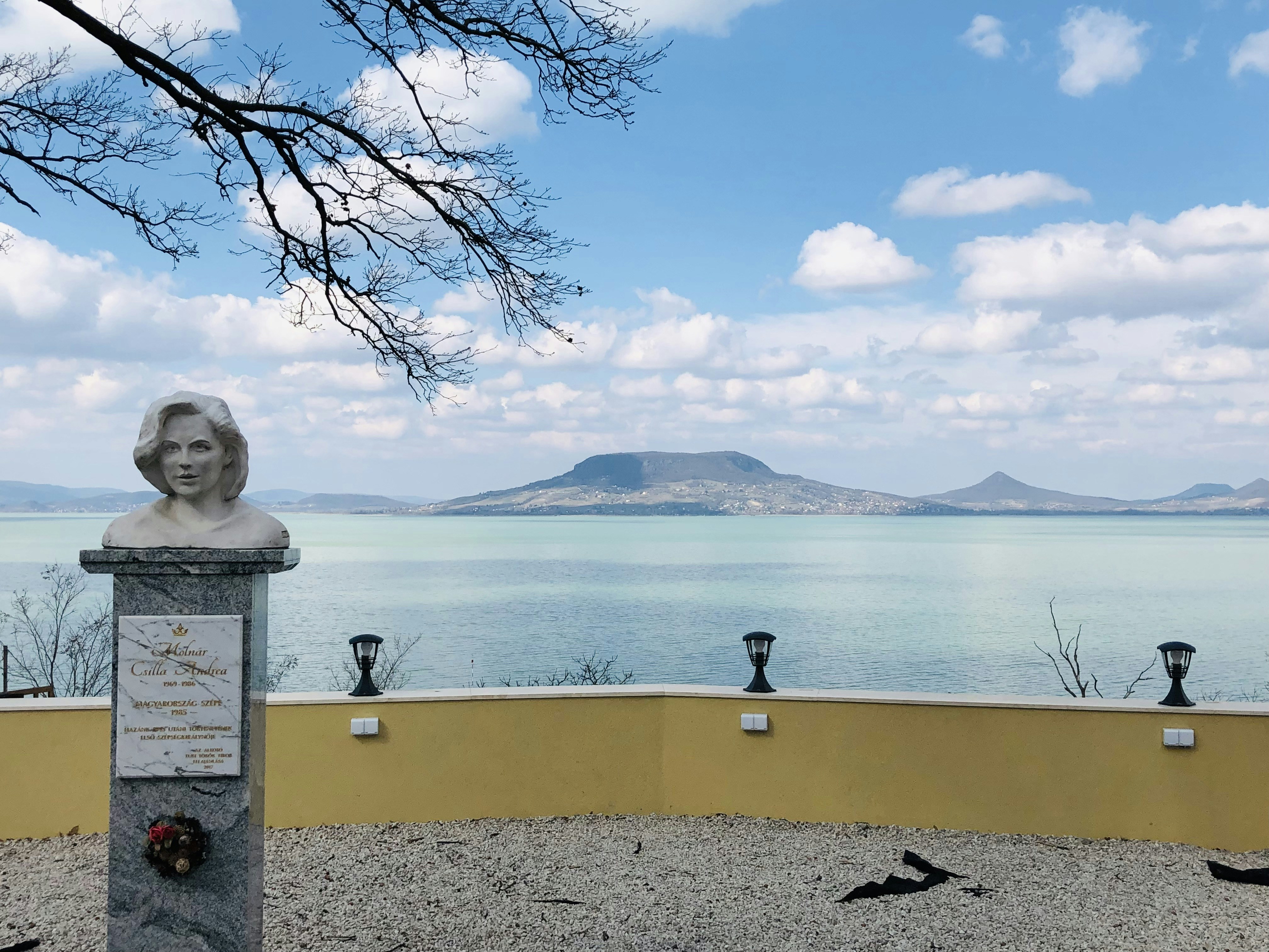 a statue of a woman near a body of water