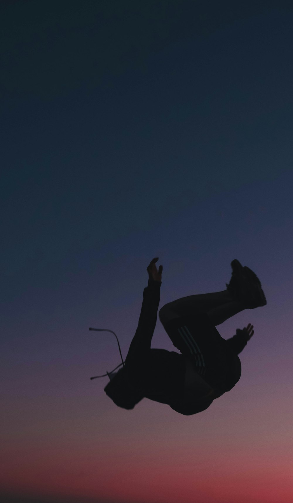 a man flying through the air while riding a skateboard