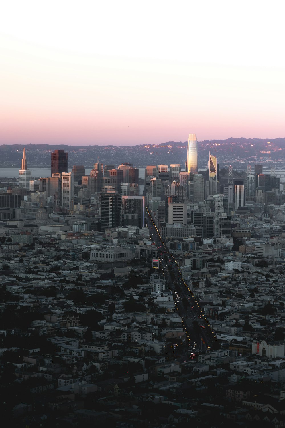 an aerial view of a city at dusk