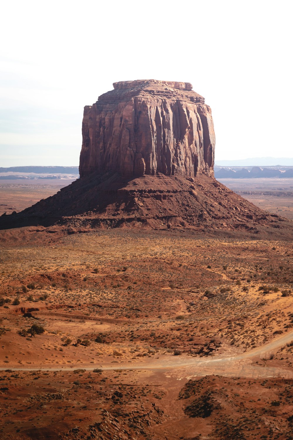 a large rock in the middle of a desert