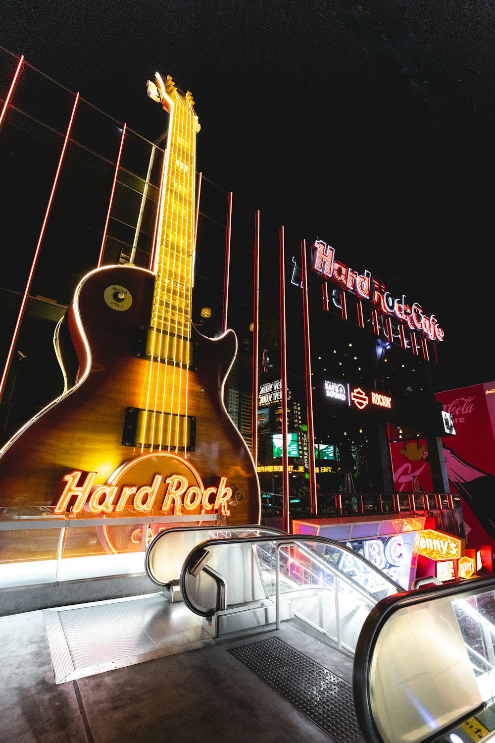 a guitar shaped sign on the side of a building