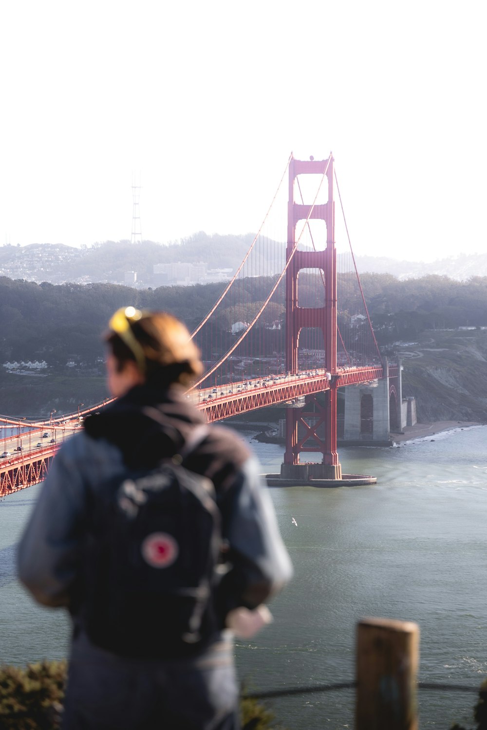 a man standing in front of the golden gate bridge