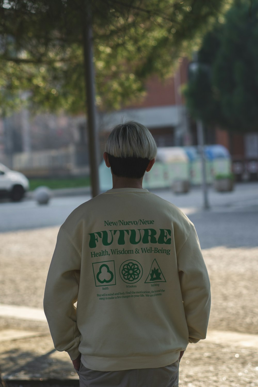 the back of a man walking down a street