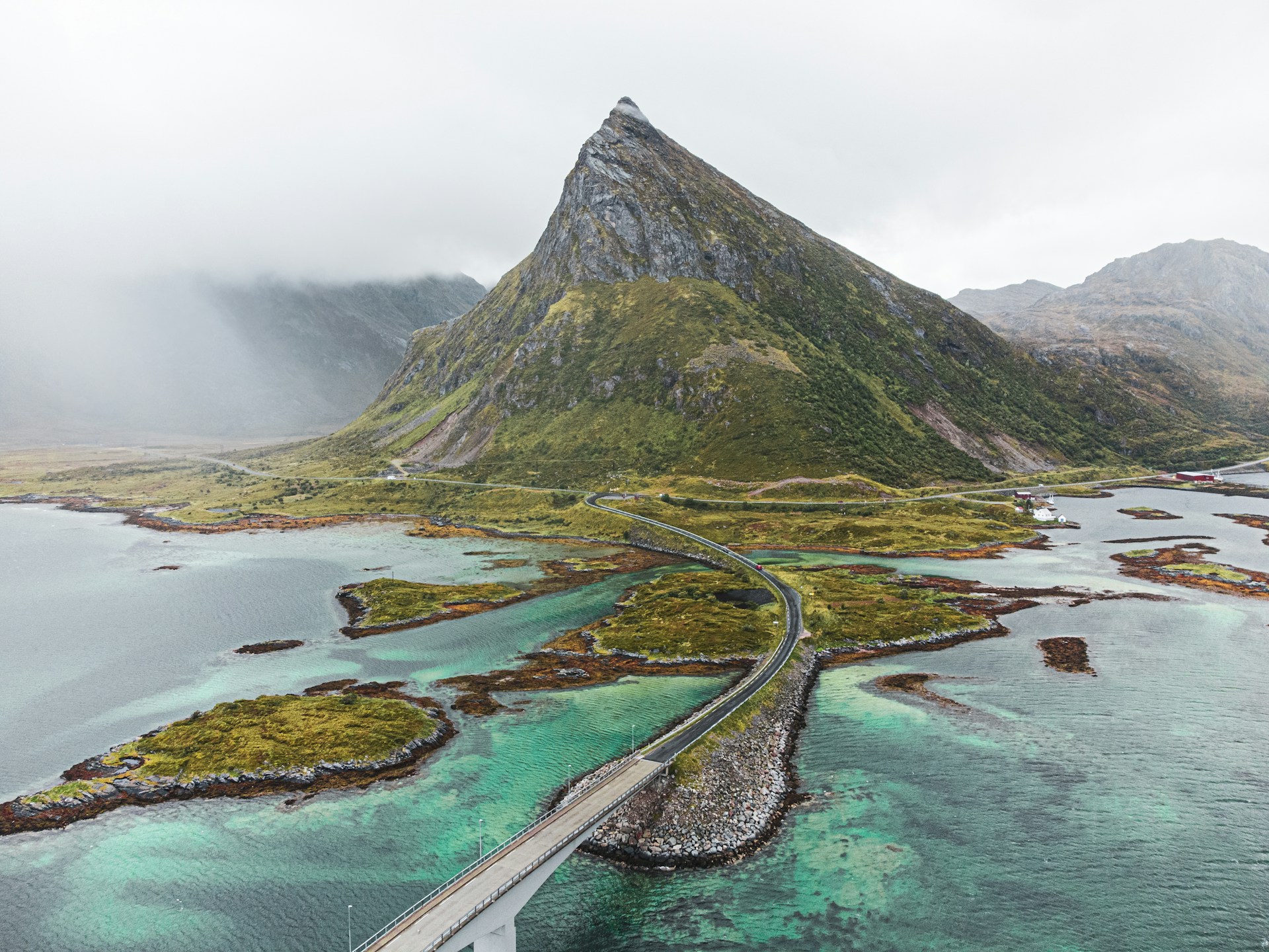 an aerial view of a bridge over a body of water