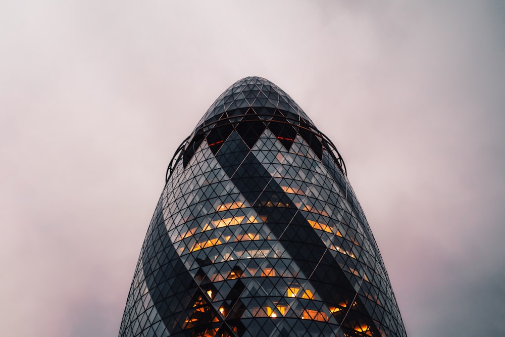 a very tall glass building with a sky background