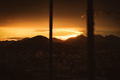A breathtaking sunset over the Monterrey city skyline with mountains in the background.