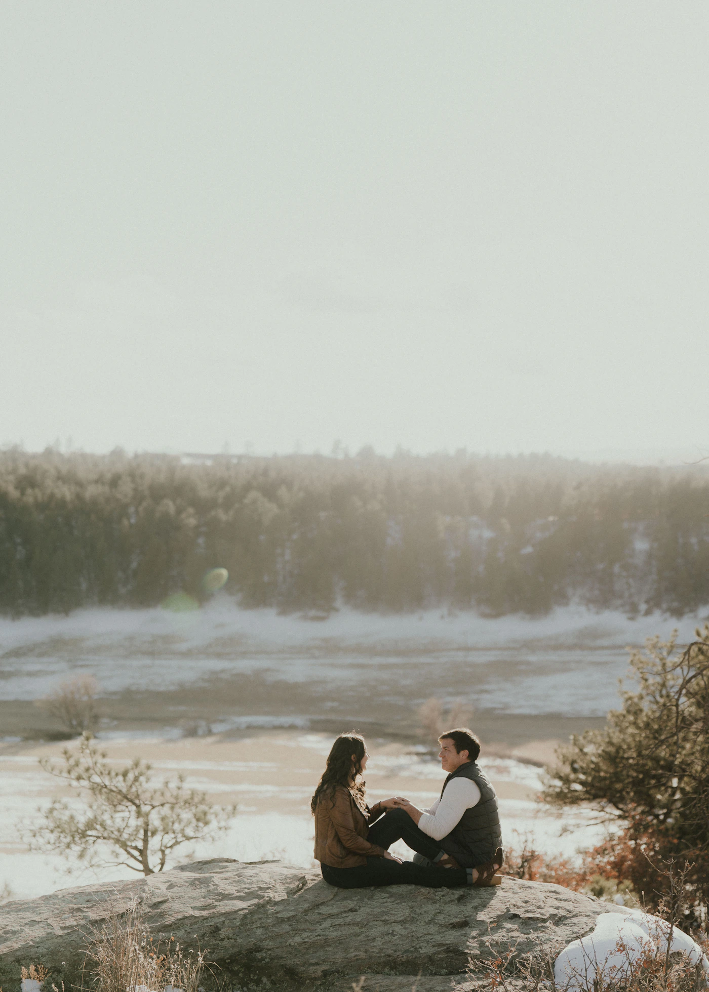 Couple in elopement attire at a Patagonian viewpoint during peak summer season with the iconic granite towers visible at sunrise