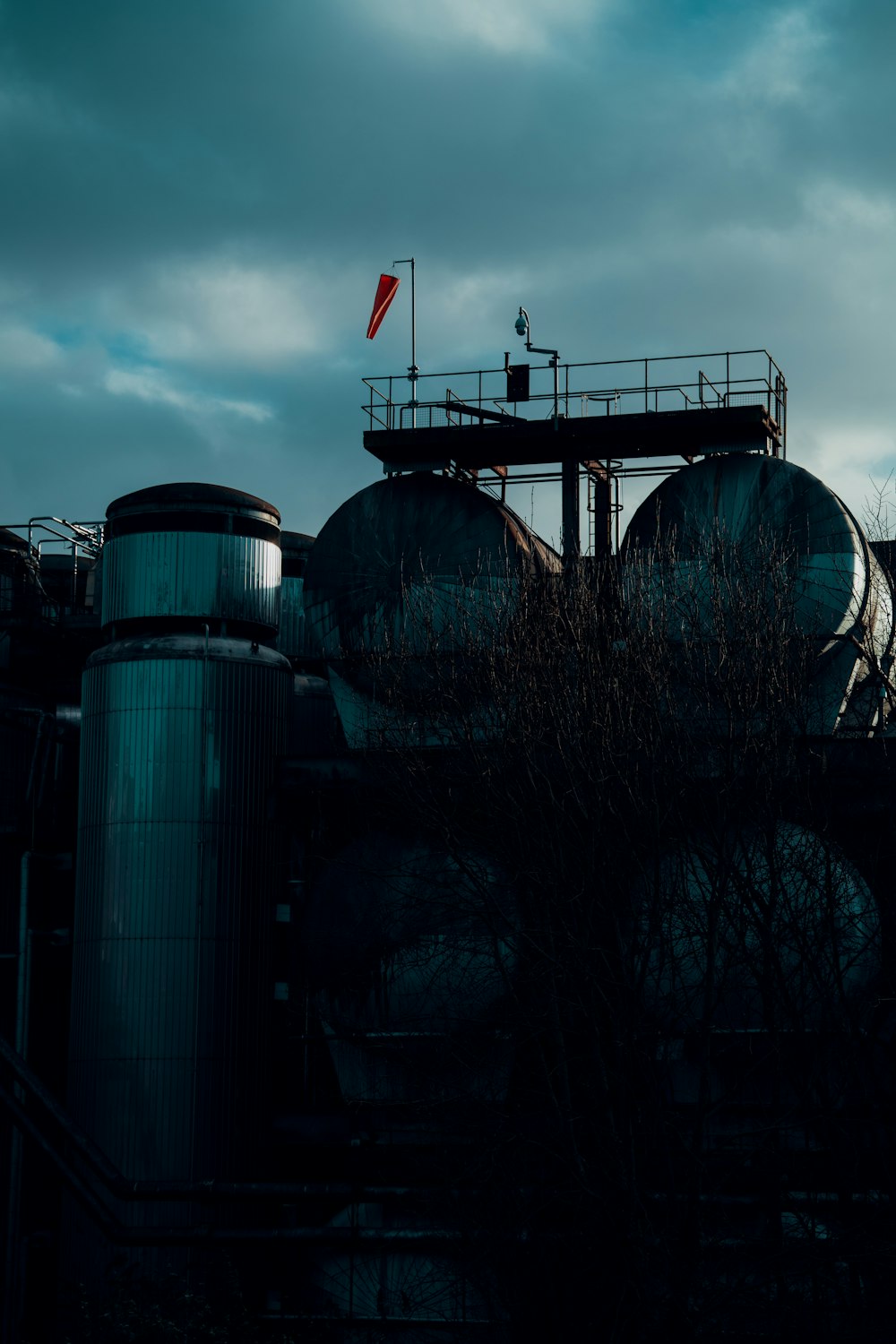 a person standing on top of a large industrial building