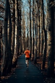 a person running down a path in the woods