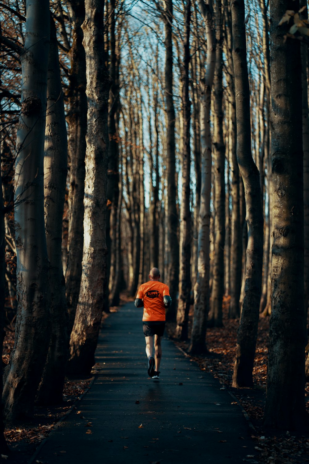 a person running down a path in the woods