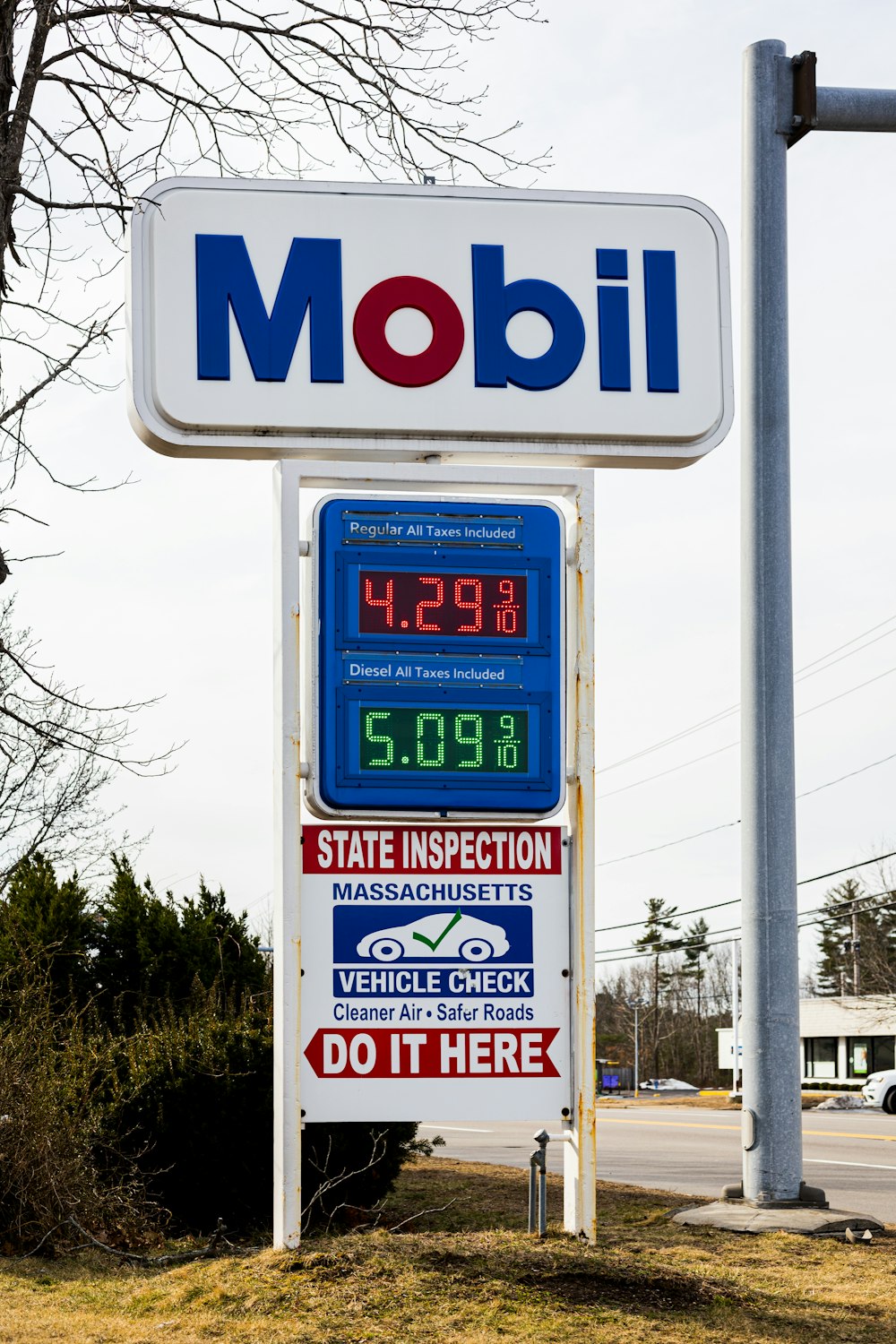 a sign for a gas station with a clock on it