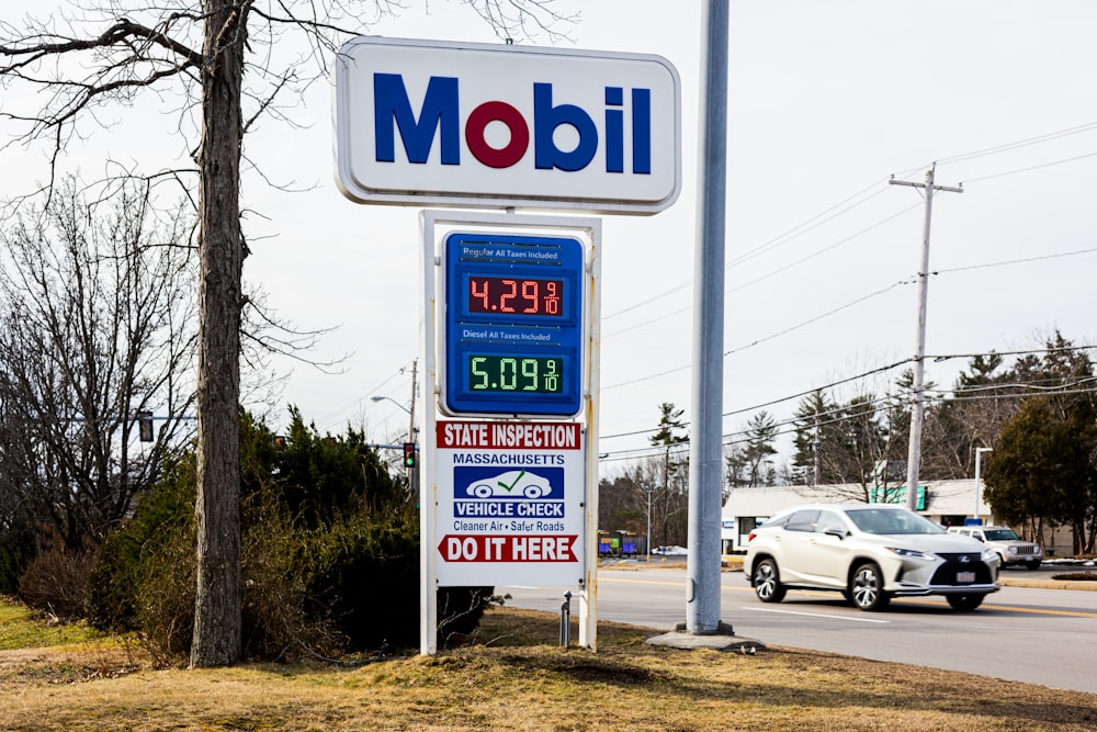 a mobil gas station sign next to a road