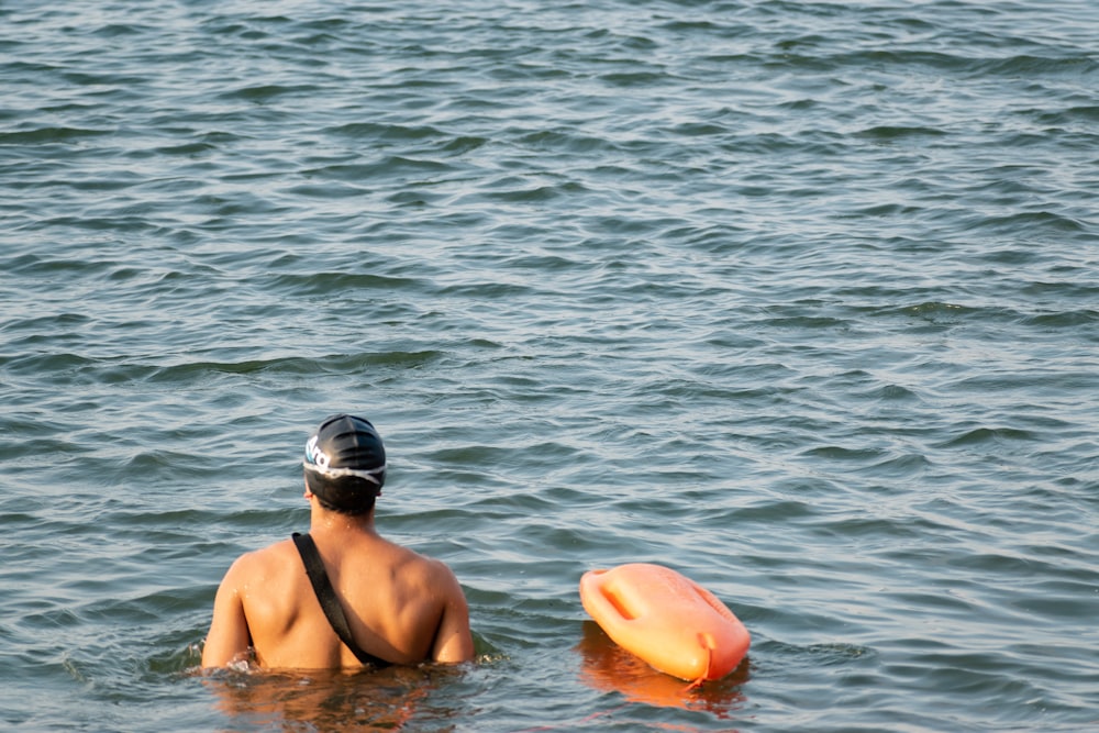 a man swimming in the water with a frisbee