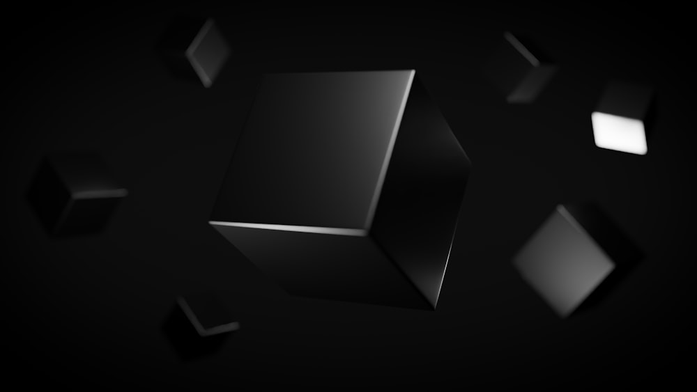 a group of black cubes floating in the air