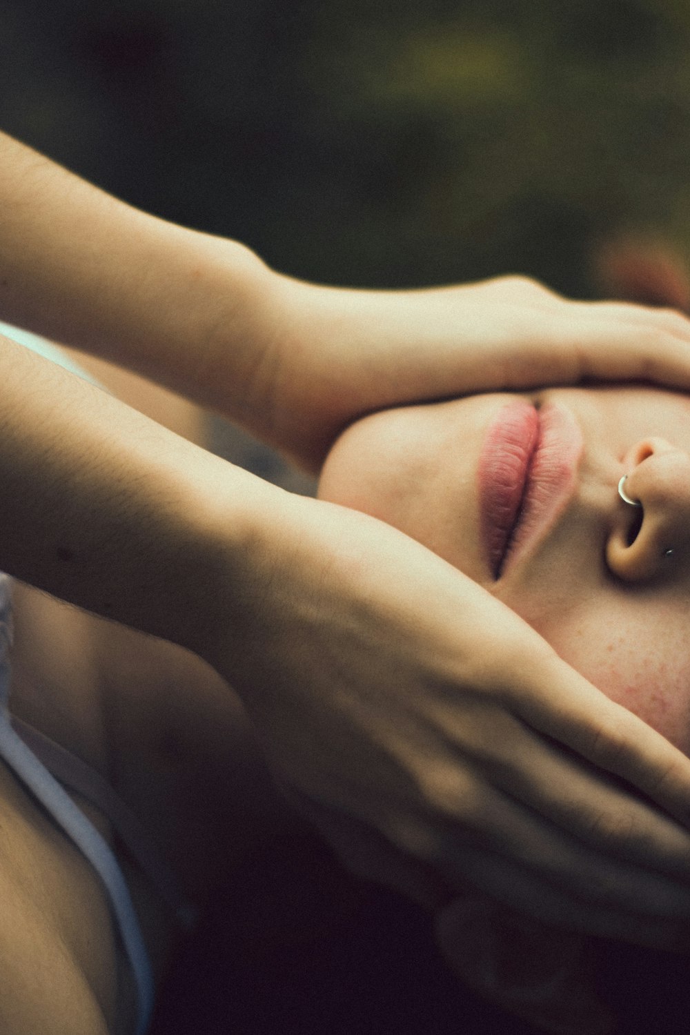 a woman is laying down with her eyes closed