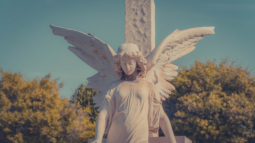 a statue of an angel holding a cross