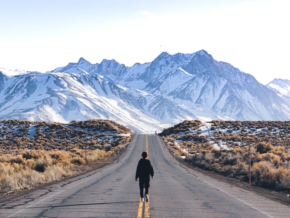 a person walking down the middle of a road