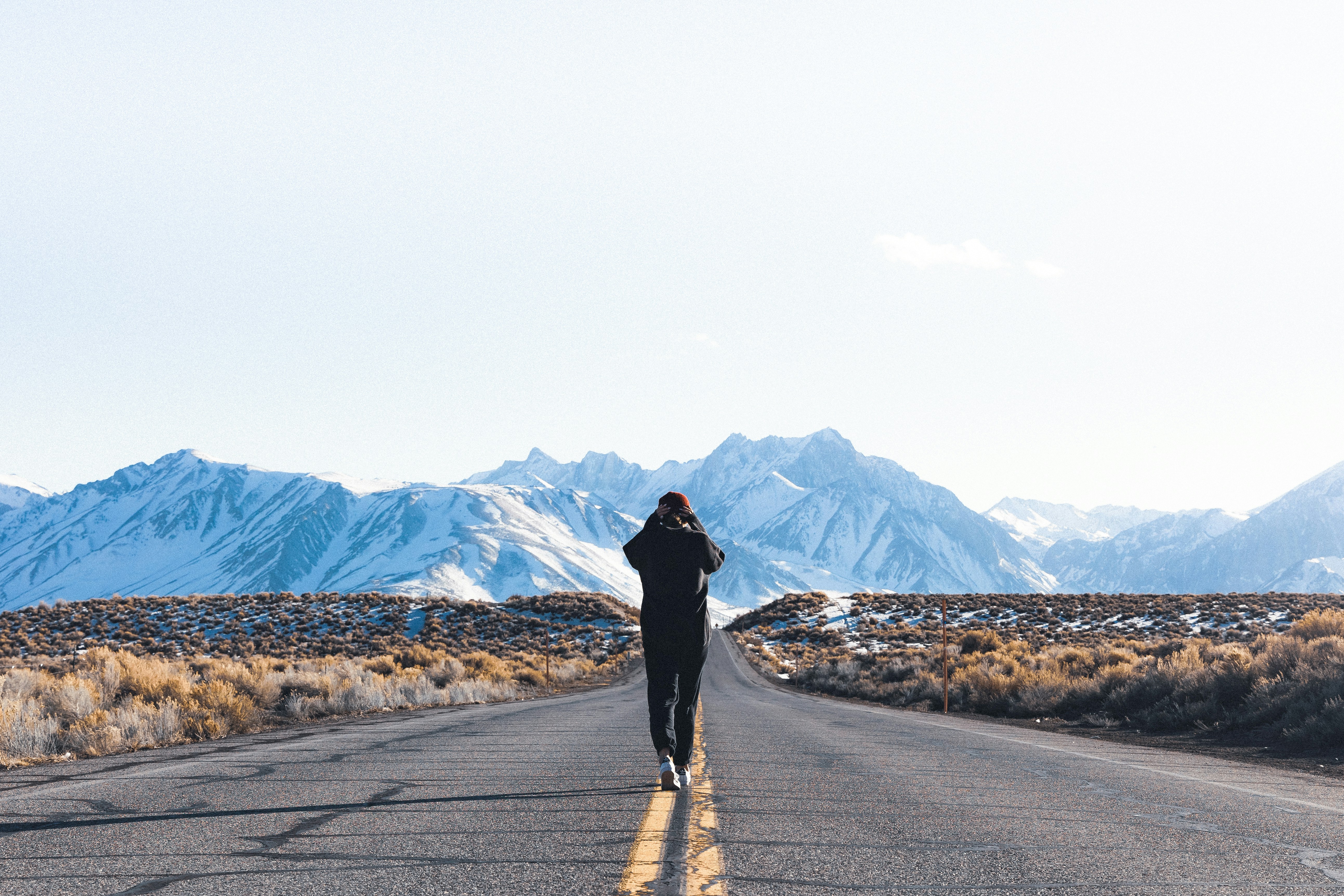 a person walking down the middle of a road