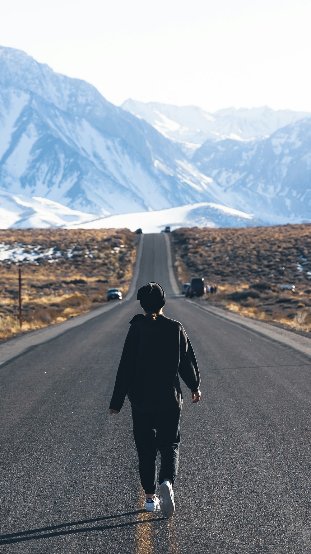 a person walking down the middle of a road