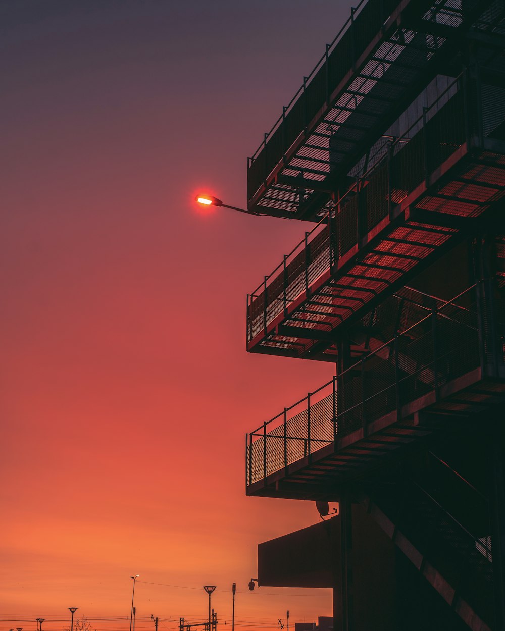 an airplane flying over a building at sunset