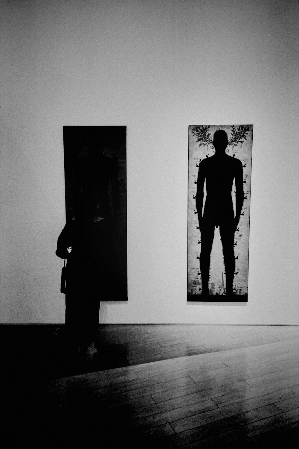 a person standing in front of a painting on a wall