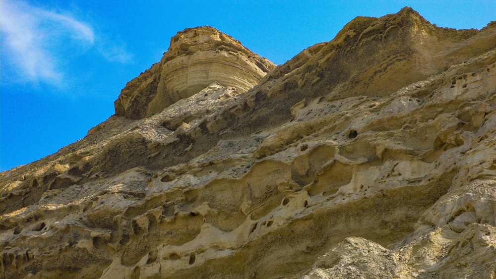 a rock formation with a blue sky in the background