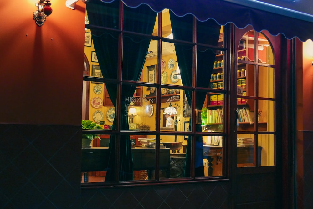 a store front with a large window and a clock on the wall