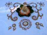 Coir discs and coins arranged artistically on a wooden surface.