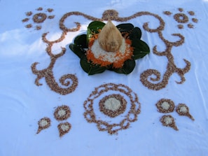 Artful arrangement of coconuts and glass jars filled with coconut oil on a natural linen cloth.