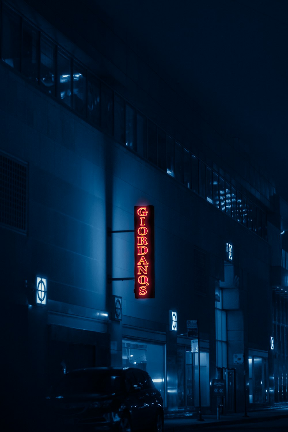 a building with a neon sign on the side of it