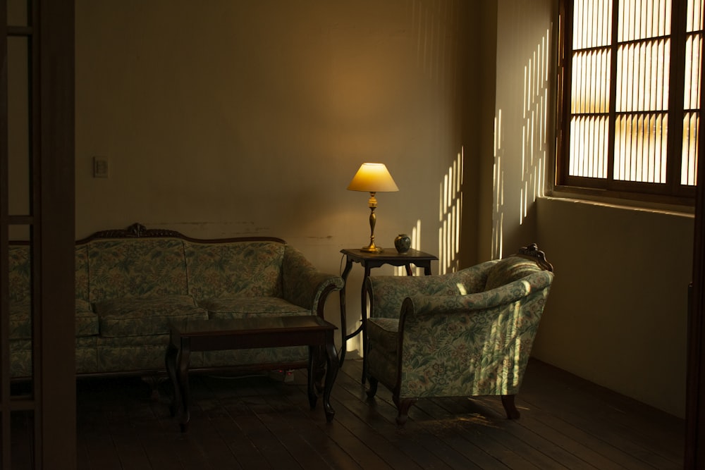 a living room with two couches and a lamp