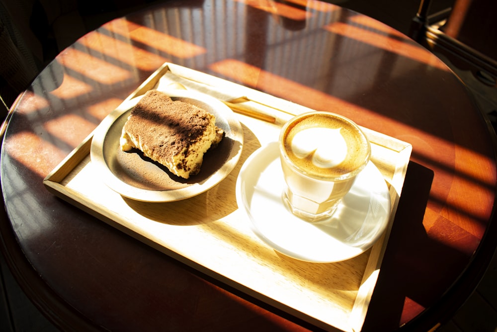 a table with a plate of food and a cup of coffee