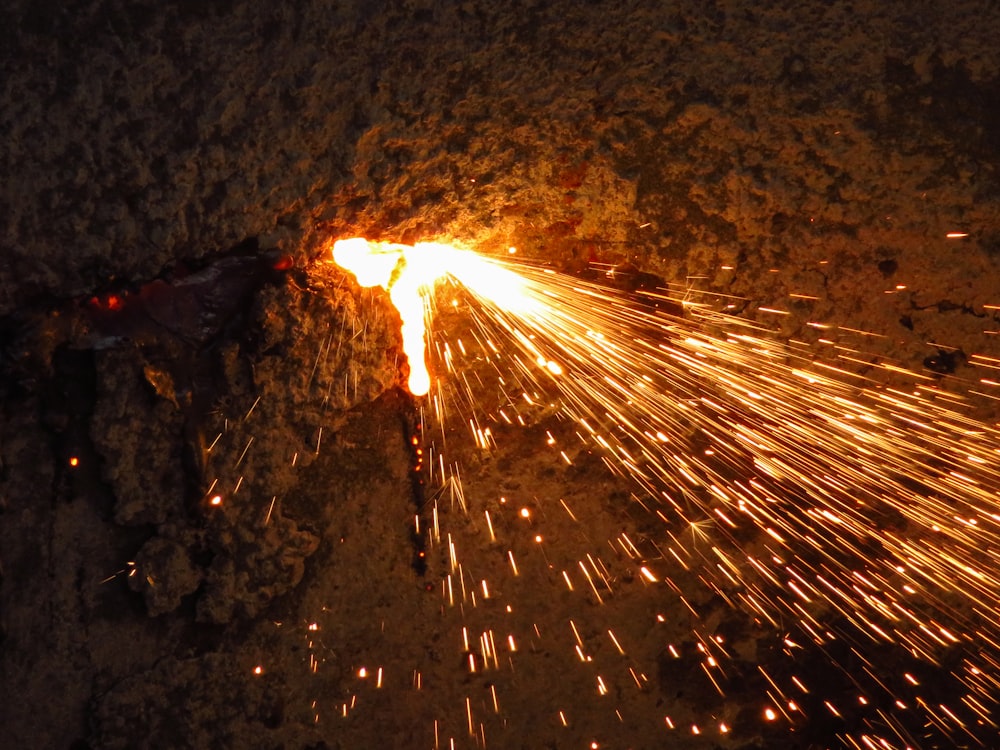 a firework is lit up in the dark