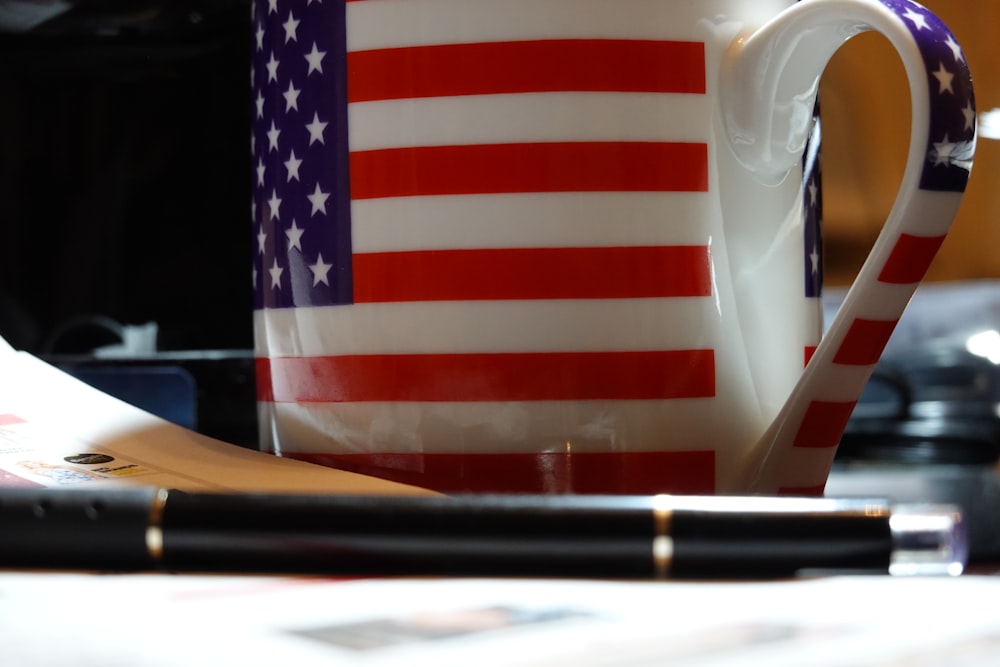 a coffee mug with the american flag painted on it