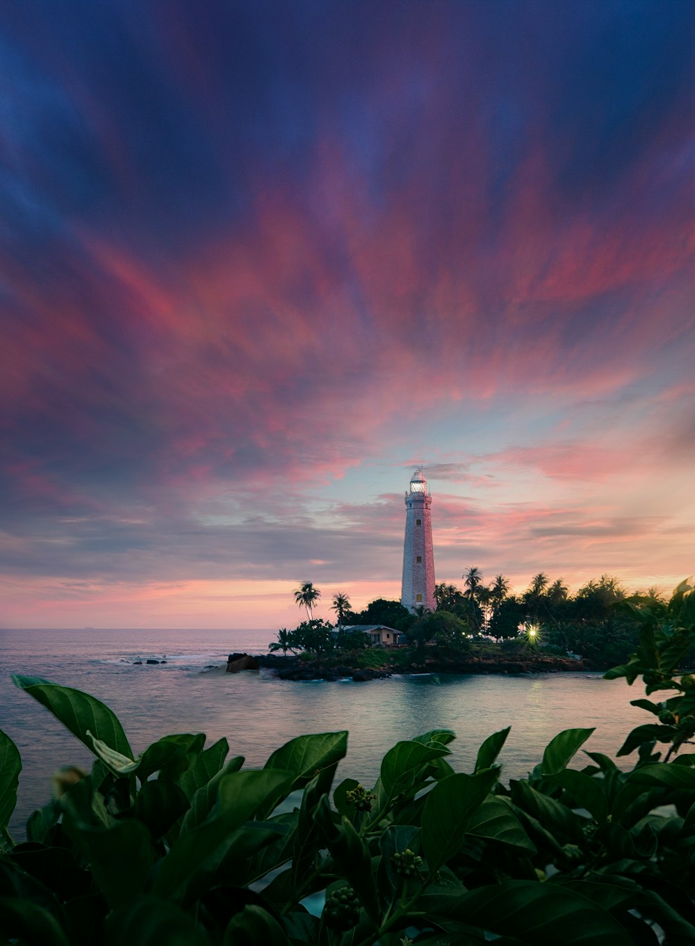 a light house sitting on top of a small island