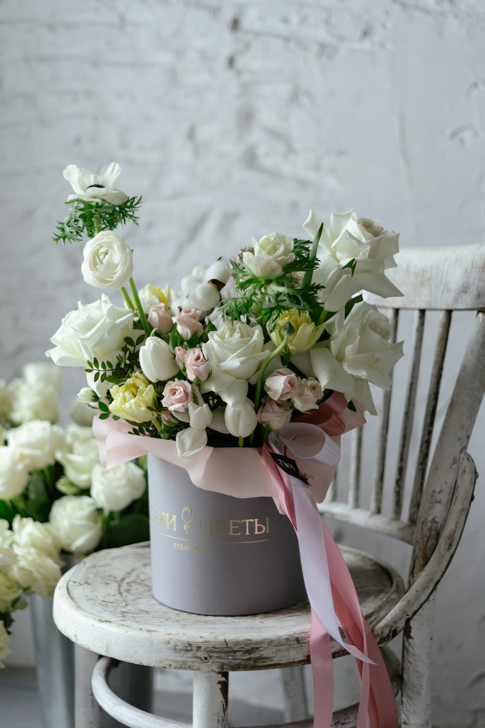 a bouquet of flowers sitting on top of a wooden chair