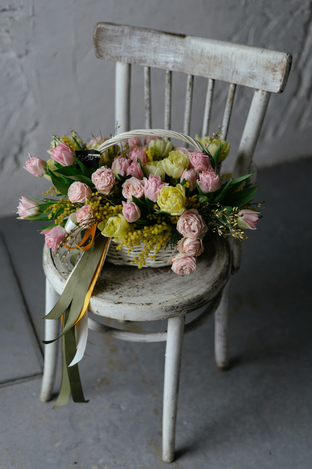 a white chair with a bunch of flowers on it