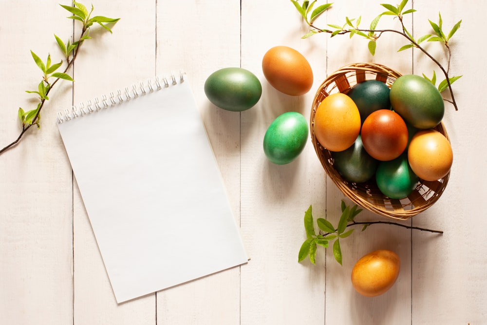 a basket of eggs and a notepad on a table