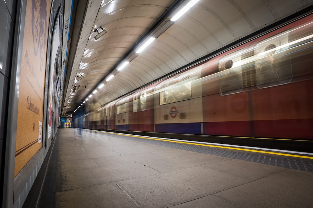 a train traveling through a train station next to a platform