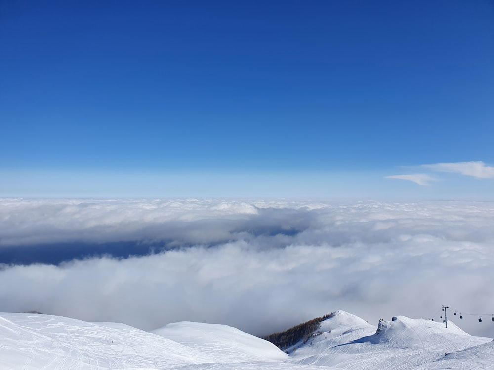 a view of a snow covered mountain with a ski lift in the distance