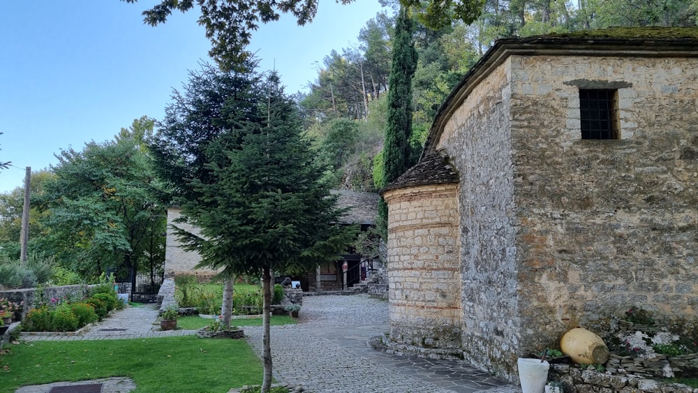 a stone building with a tree in front of it