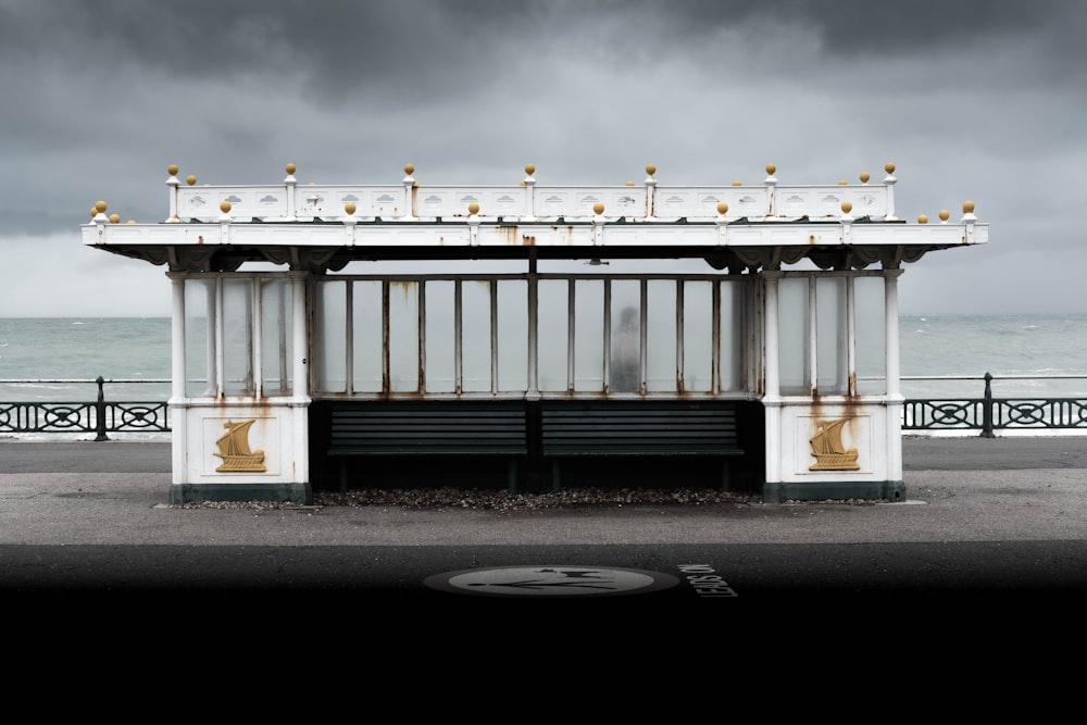 a white and black building sitting on the side of a road